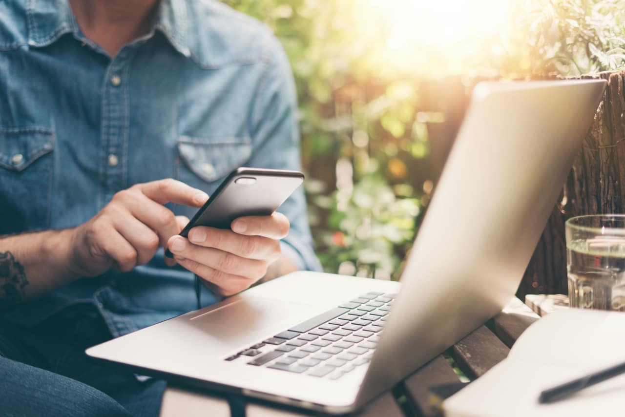 man in phone and laptop